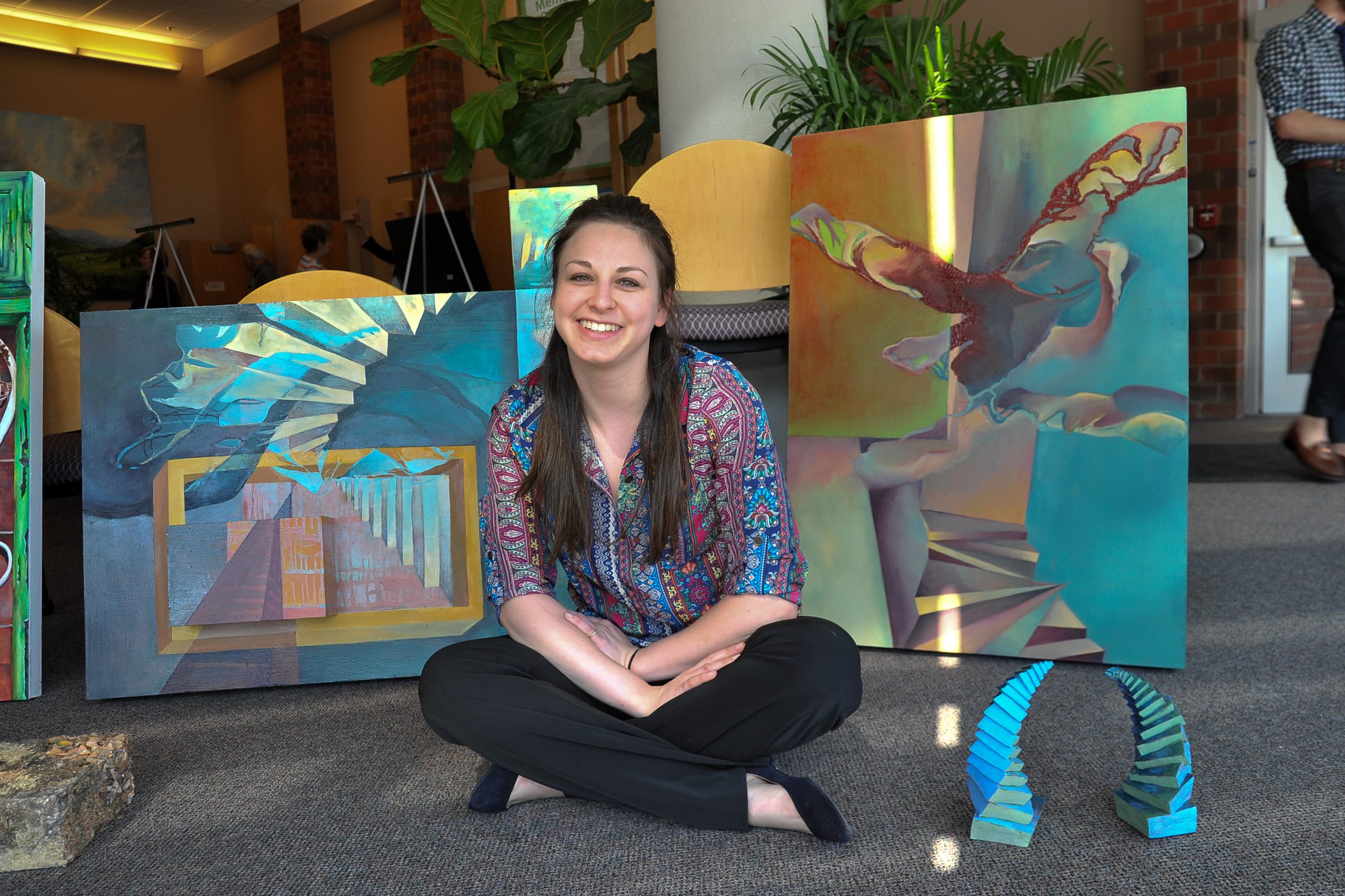 Student in front of their artwork